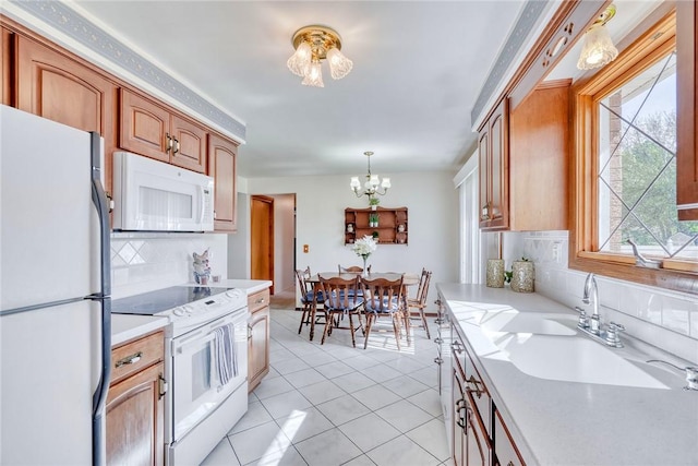 173 Dorian Ln, Greece, NY 14626 - kitchen featuring white appliances, a chandelier, light countertops, backsplash, and light tile patterned flooring