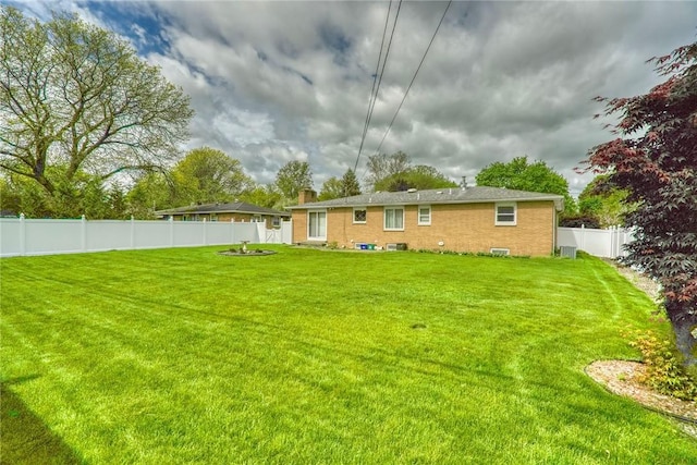 173 Dorian Ln, Greece, NY 14626 - back of house with brick siding and a chimney