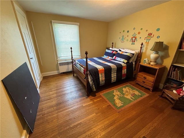 102 Highland Ave, Arcadia, NY 14513 - bedroom with radiator heating unit, wood finished floors, and baseboards