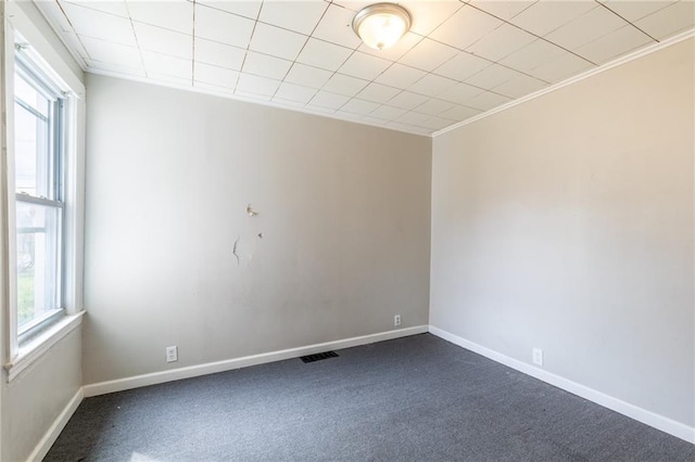 130 Cady St, Rochester, NY 14608 - empty room with plenty of natural light, dark colored carpet, baseboards, and ornamental molding