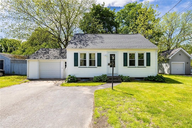 1184 Osband Ave, Macedon, NY 14502 - view of front facade with an attached garage, a front lawn, driveway, and roof with shingles