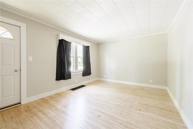 1184 Osband Ave, Macedon, NY 14502 - entrance foyer featuring ornamental molding, plenty of natural light, light wood-type flooring, and baseboards