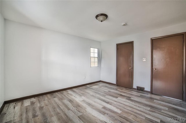 417 24th St, Niagara Falls, NY 14303 - unfurnished bedroom featuring wood finished floors and baseboards