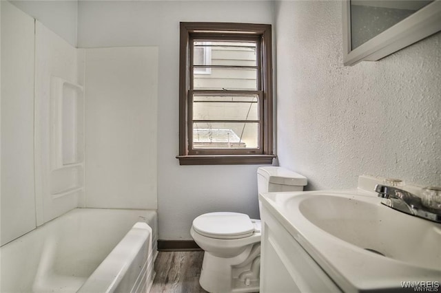 417 24th St, Niagara Falls, NY 14303 - full bathroom with healthy amount of natural light, wood finished floors, a textured wall, toilet, and vanity