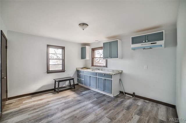 417 24th St, Niagara Falls, NY 14303 - kitchen featuring a sink, wood finished floors, baseboards, and light countertops