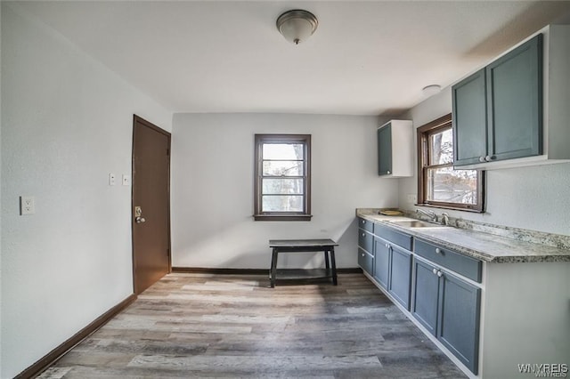 417 24th St, Niagara Falls, NY 14303 - kitchen with wood finished floors, light countertops, and a sink