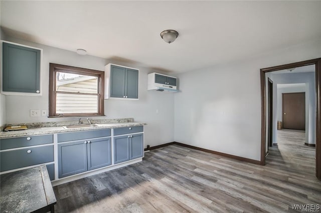 417 24th St, Niagara Falls, NY 14303 - kitchen with dark wood-style floors, a sink, baseboards, and blue cabinets