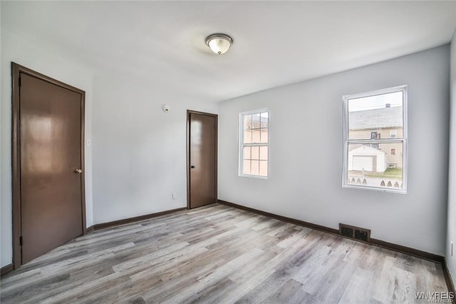 417 24th St, Niagara Falls, NY 14303 - unfurnished bedroom with wood finished floors and baseboards