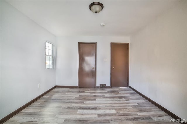 417 24th St, Niagara Falls, NY 14303 - unfurnished bedroom with wood finished floors and baseboards