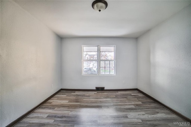 417 24th St, Niagara Falls, NY 14303 - empty room with baseboards and wood finished floors