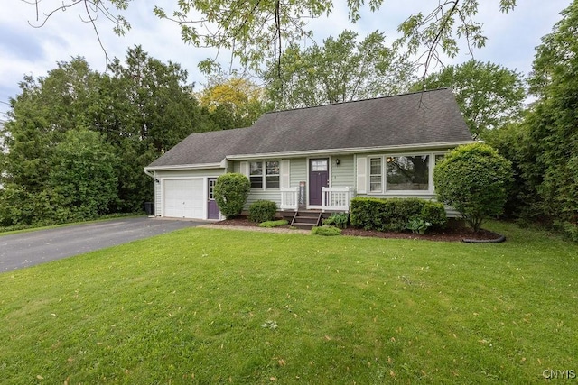 114 Osborne Dr, Manlius, NY 13057 - view of front of house featuring asphalt driveway, a garage, a front lawn, and a shingled roof