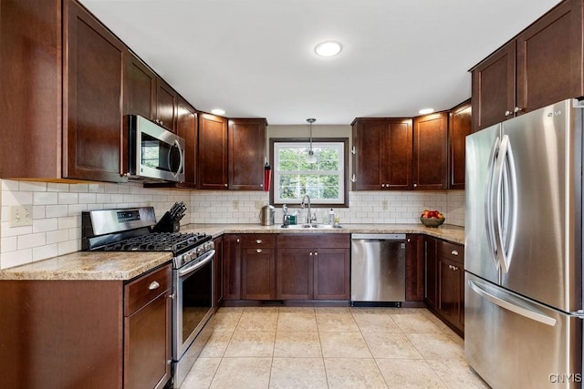 114 Osborne Dr, Manlius, NY 13057 - kitchen featuring stainless steel appliances, a sink, backsplash, light tile patterned floors, and pendant lighting