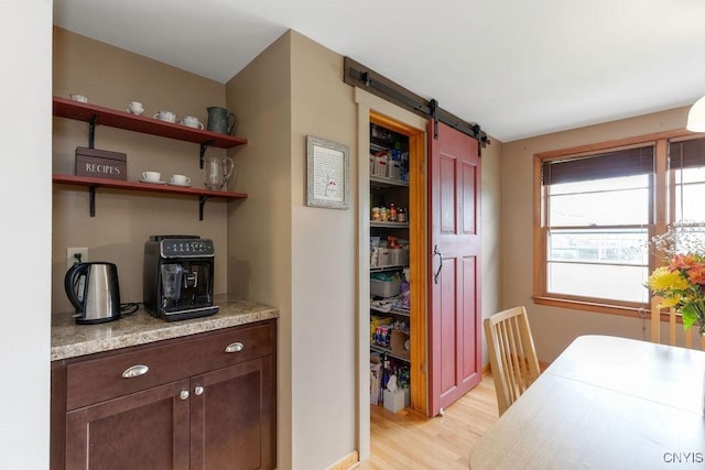 114 Osborne Dr, Manlius, NY 13057 - dining room with a barn door and light wood-style flooring