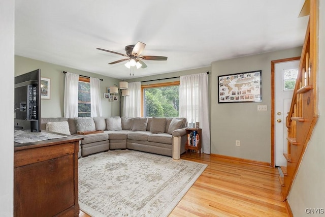 114 Osborne Dr, Manlius, NY 13057 - living room featuring light wood finished floors, stairs, ceiling fan, and baseboards