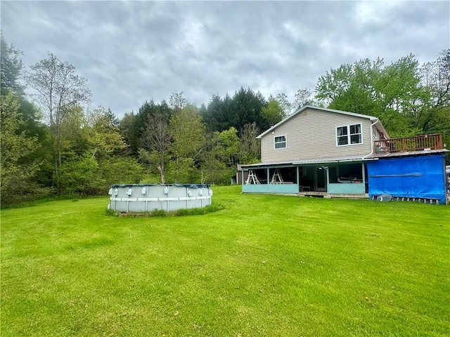 405 County Highway 12, Laurens, NY 13796 - back of house featuring a lawn, an outdoor pool, and a wooden deck