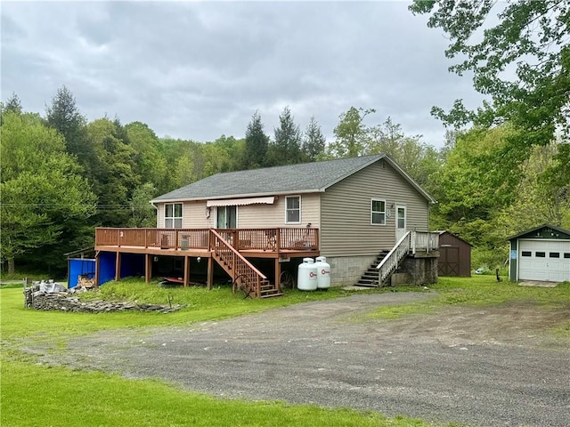 405 County Highway 12, Laurens, NY 13796 - rear view of property featuring stairway, a deck, an outbuilding, and a forest view