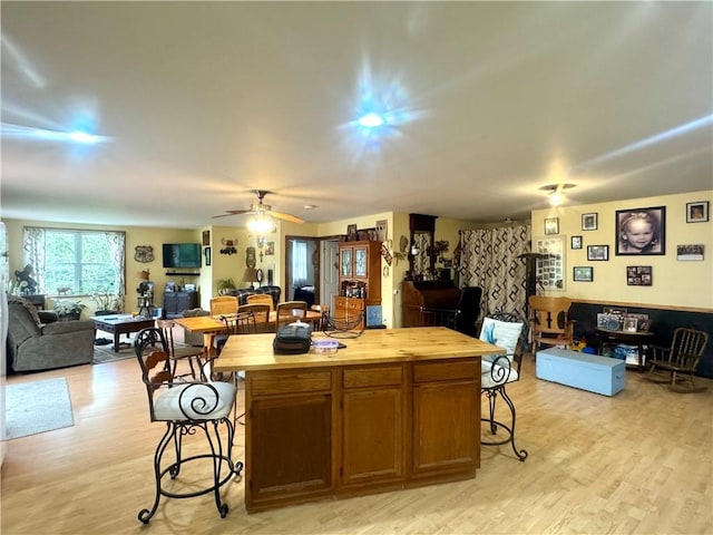405 County Highway 12, Laurens, NY 13796 - kitchen with open floor plan, a breakfast bar area, butcher block counters, light wood finished floors, and a kitchen island