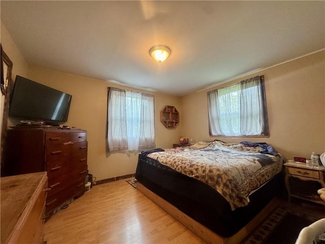 405 County Highway 12, Laurens, NY 13796 - bedroom featuring multiple windows, light wood finished floors, and baseboards