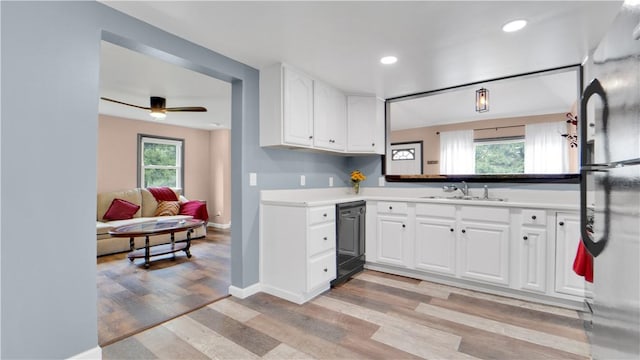 7926 Margaretta Rd, Sodus, NY 14555 - kitchen with dishwasher, a sink, light wood-style flooring, white cabinetry, and recessed lighting
