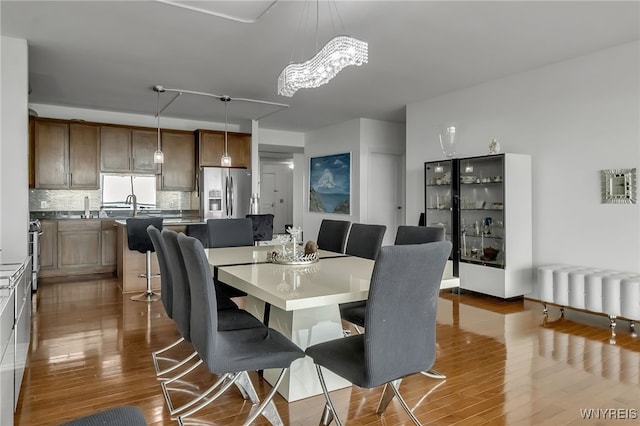 132 Lakefront Blvd Unit 403, Buffalo, NY 14202 - dining area with radiator, wood finished floors, and a chandelier