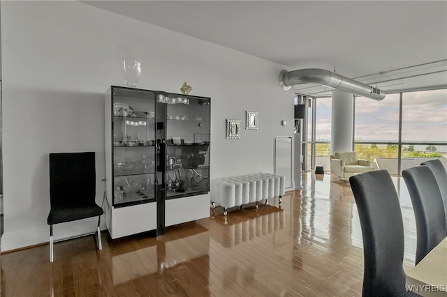132 Lakefront Blvd Unit 403, Buffalo, NY 14202 - dining room featuring a wall of windows, wood finished floors, and radiator heating unit