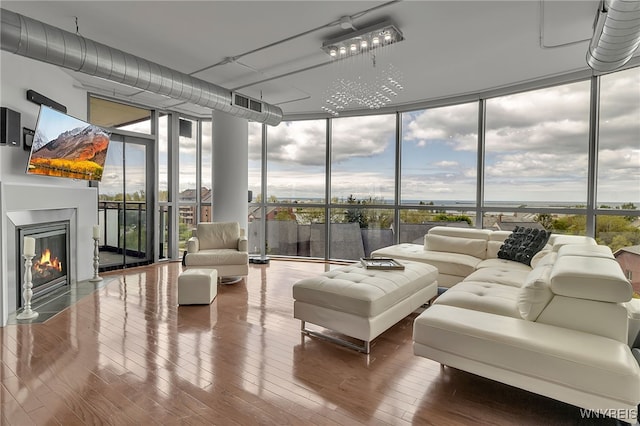 132 Lakefront Blvd Unit 403, Buffalo, NY 14202 - living area featuring floor to ceiling windows, wood finished floors, a fireplace with flush hearth, and plenty of natural light
