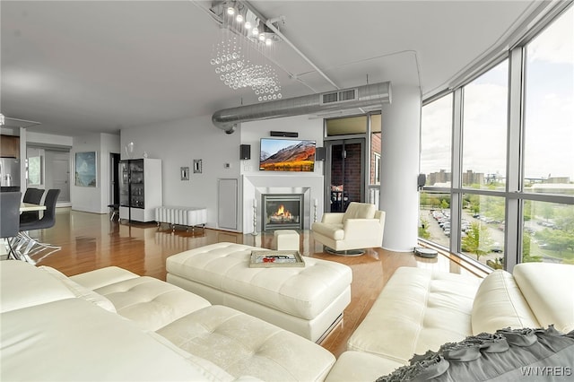 132 Lakefront Blvd Unit 403, Buffalo, NY 14202 - living area featuring wood finished floors, a glass covered fireplace, and a wall of windows