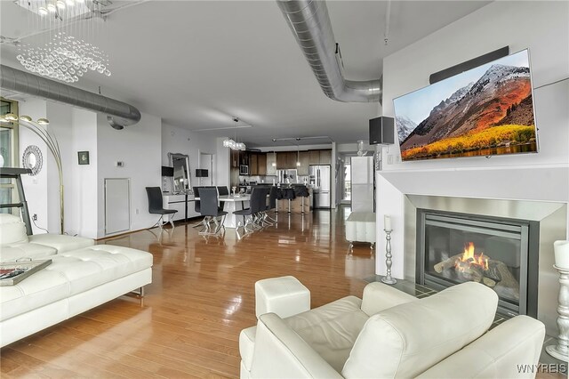 132 Lakefront Blvd Unit 403, Buffalo, NY 14202 - living room with light wood-type flooring and a glass covered fireplace