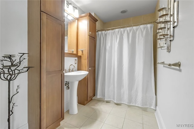 132 Lakefront Blvd Unit 403, Buffalo, NY 14202 - bathroom with tile patterned flooring, a shower with curtain, and a sink
