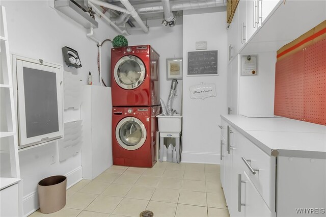 132 Lakefront Blvd Unit 403, Buffalo, NY 14202 - laundry area with cabinet space, stacked washer / drying machine, and light tile patterned flooring