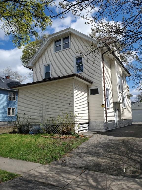 21 Manitou St, Rochester, NY 14621 - view of side of property featuring a lawn and driveway