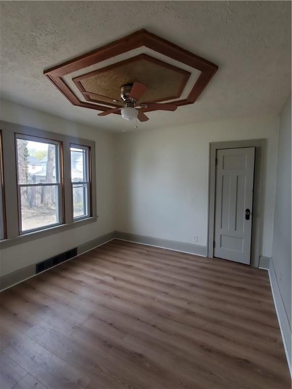 21 Manitou St, Rochester, NY 14621 - unfurnished room with a textured ceiling, wood finished floors, a ceiling fan, and baseboards
