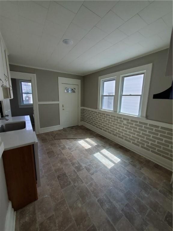 21 Manitou St, Rochester, NY 14621 - kitchen featuring a sink, wainscoting, white cabinets, and light countertops