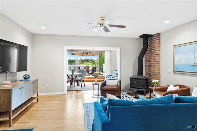 18 E Genesee St Unit 1, Skaneateles, NY 13152 - living area featuring light wood-type flooring, a wood stove, a ceiling fan, baseboards, and recessed lighting
