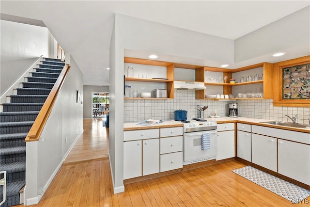 18 E Genesee St Unit 1, Skaneateles, NY 13152 - kitchen featuring white range with electric stovetop, a sink, open shelves, light countertops, and recessed lighting