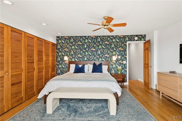 18 E Genesee St Unit 1, Skaneateles, NY 13152 - bedroom with wallpapered walls, an accent wall, wood finished floors, baseboards, and recessed lighting