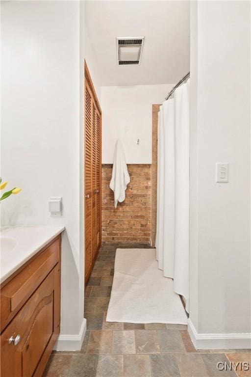 18 E Genesee St Unit 1, Skaneateles, NY 13152 - full bath with vanity, stone finish flooring, and baseboards