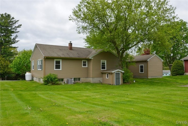 47388 Dingman Point Rd, Alexandria, NY 13607 - rear view of property featuring cooling unit, a chimney, and a lawn