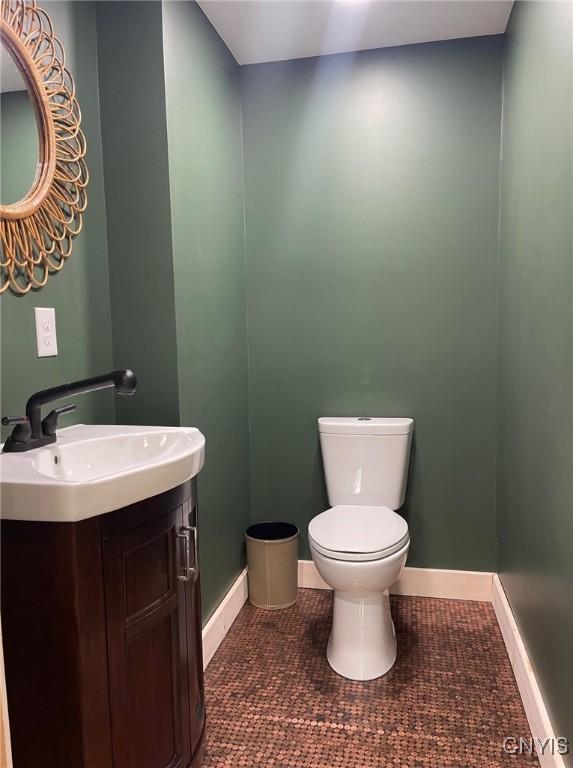 4456 Palmer Rd, Annsville, NY 13471 - half bathroom with toilet, baseboards, vanity, and tile patterned flooring