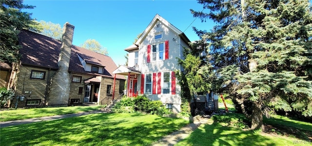 317 Portage Rd, Niagara Falls, NY 14303 - view of front of house with a front yard and a chimney