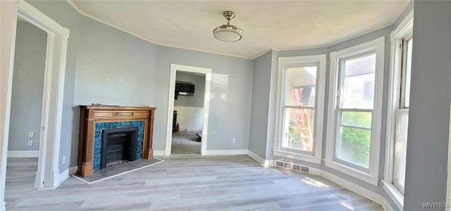 317 Portage Rd, Niagara Falls, NY 14303 - unfurnished dining area featuring healthy amount of natural light, wood finished floors, ornamental molding, and a premium fireplace