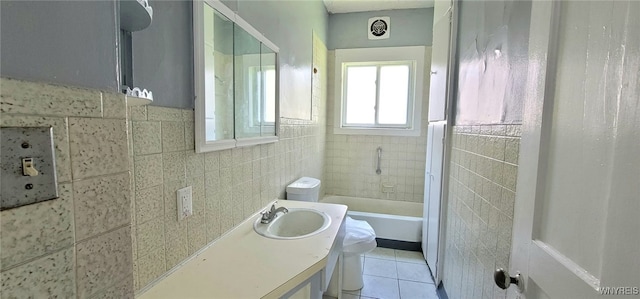 317 Portage Rd, Niagara Falls, NY 14303 - full bath featuring toilet, tile walls, tile patterned flooring, vanity, and washtub / shower combination