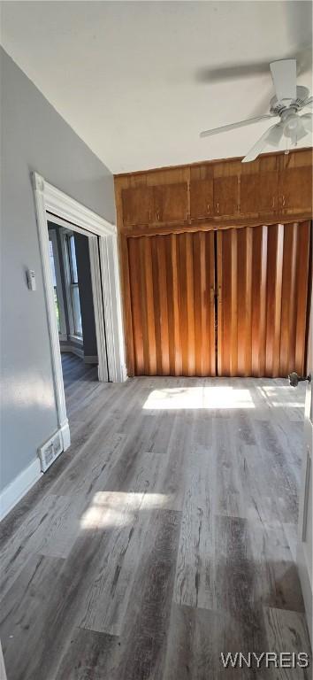 317 Portage Rd, Niagara Falls, NY 14303 - unfurnished living room with wood finished floors, a ceiling fan, and baseboards