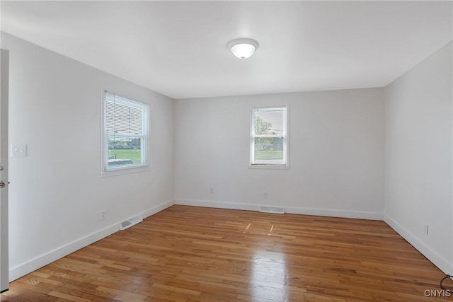 103 Pulaski St, Syracuse, NY 13204 - spare room featuring healthy amount of natural light, light wood-type flooring, and baseboards