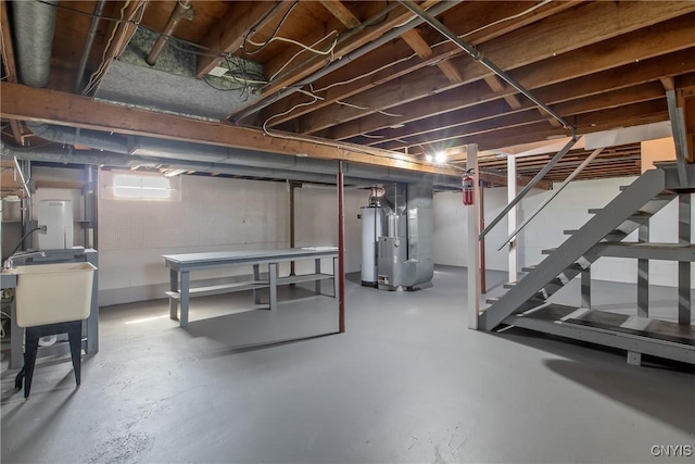 103 Pulaski St, Syracuse, NY 13204 - below grade area featuring heating unit, stairs, and a sink