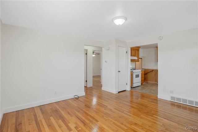 103 Pulaski St, Syracuse, NY 13204 - unfurnished living room with light wood-style floors, baseboards, and ceiling fan