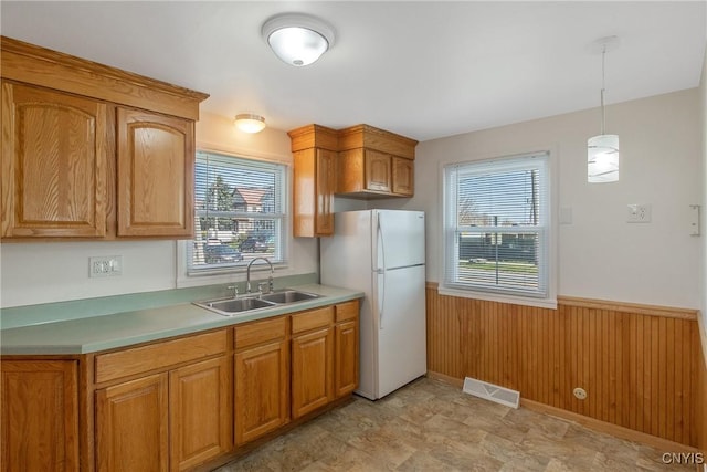 103 Pulaski St, Syracuse, NY 13204 - kitchen featuring freestanding refrigerator, a sink, wainscoting, light countertops, and pendant lighting