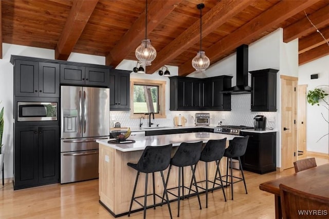 7317 Concord Rd, Concord, NY 14141 - kitchen with stainless steel appliances, dark cabinetry, wall chimney range hood, a sink, and wood ceiling