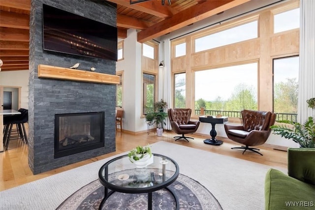 7317 Concord Rd, Concord, NY 14141 - living room with a fireplace, wood finished floors, wood ceiling with exposed beams, and a towering ceiling