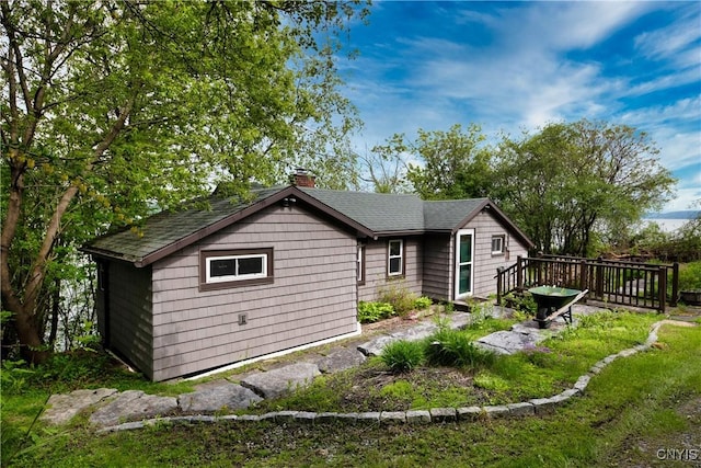 2900 W Lake Rd, Skaneateles, NY 13152 - rear view of house featuring a chimney, a wooden deck, and a shingled roof